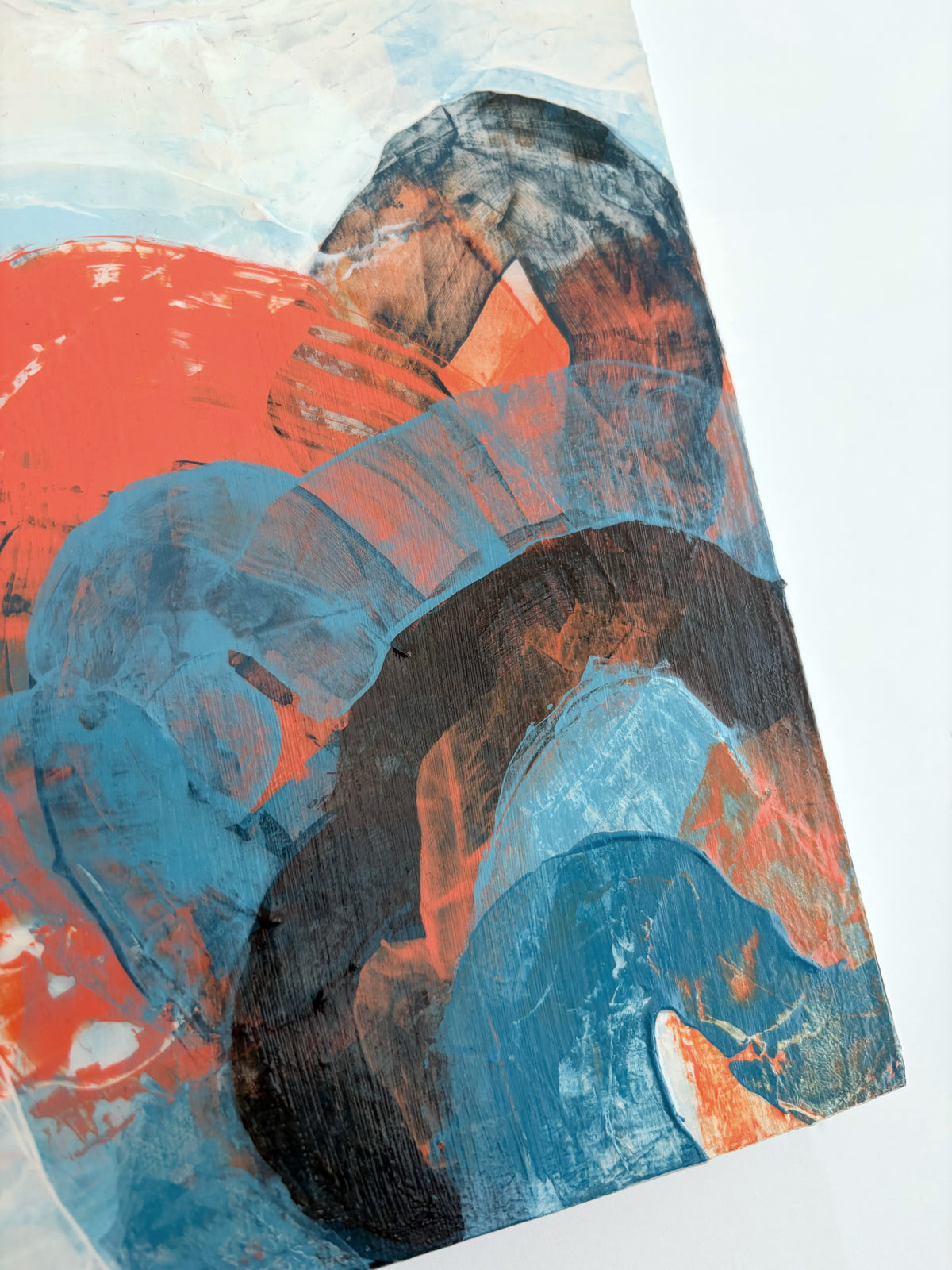 Abstract acrylic painting featuring expressive, textured brushstrokes in vibrant blue, deep orange, and brown on a white background.