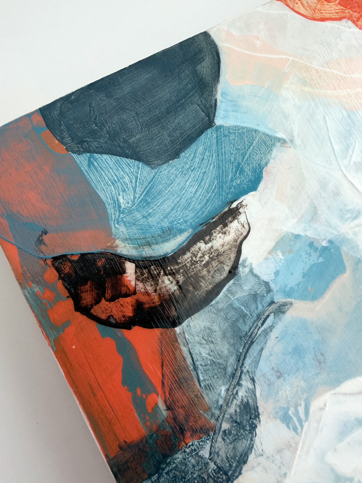 Abstract acrylic painting on wooden panel featuring textured brushstrokes of light blue, orange, dark brown, and white.